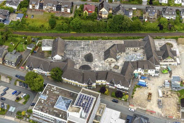 Aerial view, demolition of the former Eins-A complex on Schulstrasse, Bad Berleburg, Wittgensteiner Land, North Rhine-Westphalia, Germany, demolition, demolition work, demolition phase, architecture, excavator, construction site, construction industry, deconstruction, development, progress, building, building demolition, history, infrastructure, landscape, aerial view, aerial perspective, modernisation, location, region, renovation, Schulstrasse, rubble, city, city view, city life, urban, change, reconstruction, German village, former Eins-A complex, European location