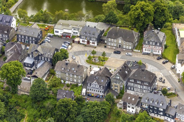 Aerial view, Goetheplatz in the town centre with monument Wilhelm I, historic houses, restaurants and cafés with parasols, Bad Berleburg, Wittgensteiner Land, North Rhine-Westphalia, Germany, old building, old town, architecture, visitors, cafés, monument, monuments, recreation, Europe, open air, leisure, gastronomy, building, Goetheplatz, culture, town centre, perspective, squares, restaurants, sights, summer, parasols, town centre, street scene, daytime, tourism, tradition, Wilhelm I, public square