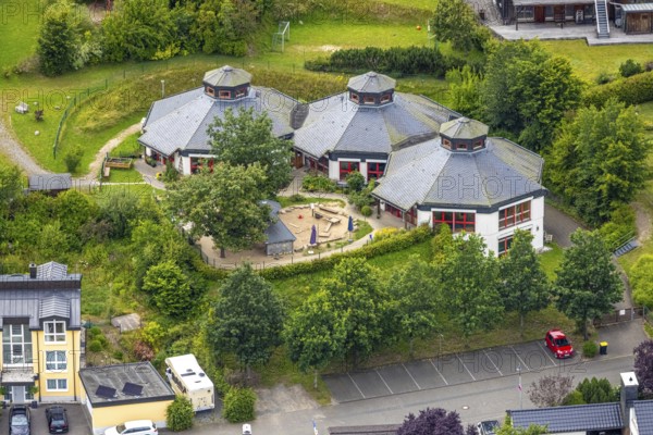 Aerial view, AWO Family Centre Laubfrosch Kindergarten, octagonal building and playground, Bad Berleburg, Wittgensteiner Land, North Rhine-Westphalia, Germany, AWO Family Centre Laubfrosch, architecture, outdoor area, contemplation, education, village, facilities, parents, educators, upbringing, leisure, early childhood education, building, community, green spaces, infrastructure, children, kindergarten, kindergarten children, landscape, nature, perspective, summer, social centre, play equipment, playground, structure, daylight, entertainment, octagonal, rural, educational, public facilities