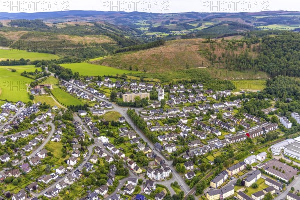 Aerial view, high-rise buildings and housing estate on Brandenburger Straße, forest area with forest damage and distant view, Bad Berleburg, Wittgensteiner Land, North Rhine-Westphalia, Germany, architecture, Brandenburger Straße, trees, drone image, distant view, forestry, buildings, high-rise buildings, real estate, infrastructure, landscape, nature, panorama, damage, settlement, city, urban development, environment, urban, forest area, forest damage, housing estate, flats, rural
