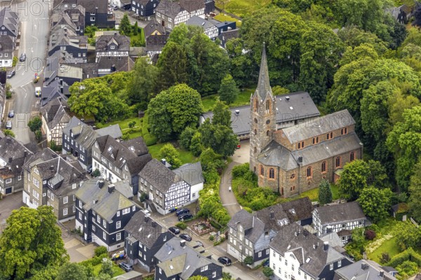 Aerial view, protestant town church and green trees on Schlossstraße, residential area with historic houses Bad Berleburg, Wittgensteiner Land, North Rhine-Westphalia, Germany, old town, architecture, Bad Berleburg, trees, roofs, building, community, history, green trees, church, church tower, culture, aerial view, nature, panorama, region, religion, Schlossstraße, sight, skyline, summer, town, town view, town centre, day, tourism, urban, residential area, residential houses, protestant town church, historic houses, rural, traditional