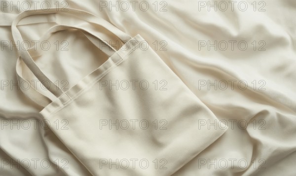 A cream canvas bag on a draped fabric with soft lighting emphasizing texture. AI generated