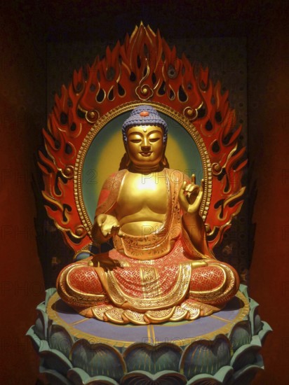 A buddha sculpture inside of a temple seen in in Singapore