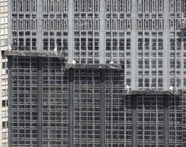 Detail shot of some facade workers on a skyscraper facade in New York (USA)