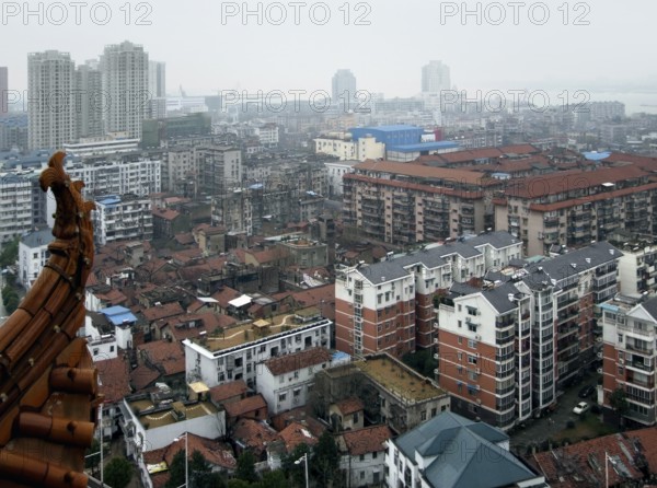 Detail of Wuhan, a big city in China. High angle shot seen from the historic Yellow Crane Tower in misty ambiance