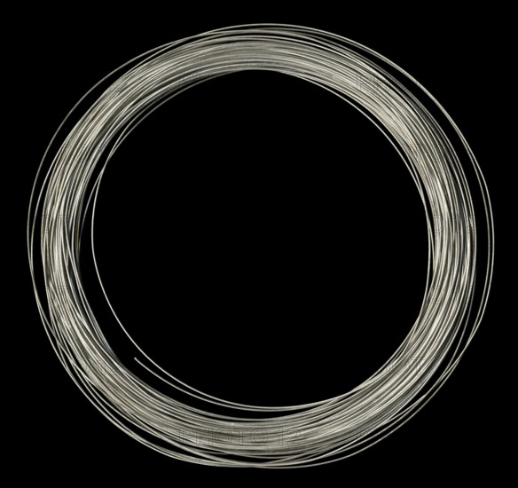 Studio photography of rolled silver wire in black back