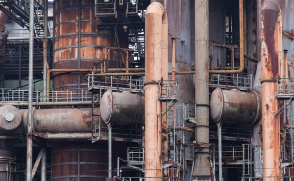Weathered rusty industrial scenery with old corroded steel girders and metal tubes