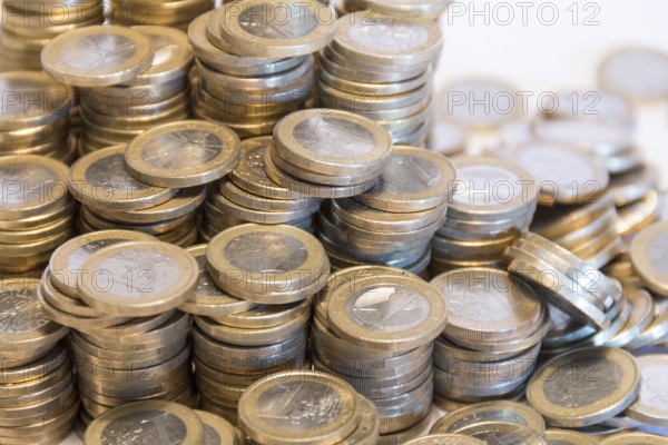 Lots of stacked 1 euro coins