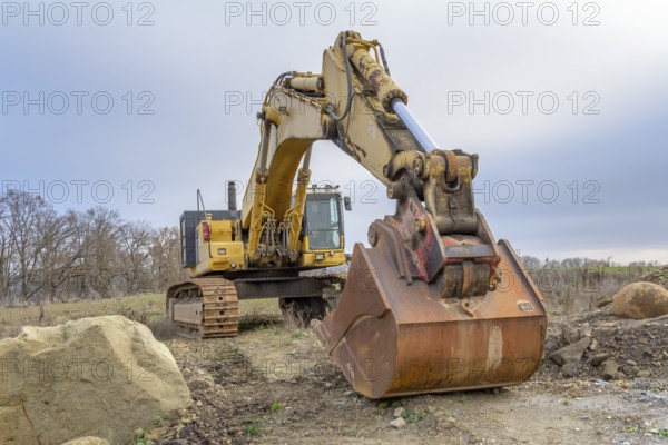 A yellow Excavator in stony ambiance