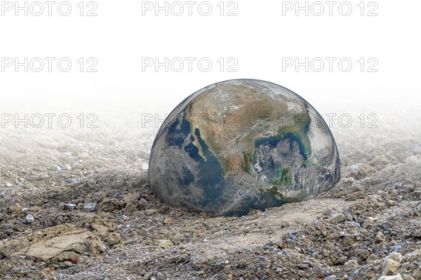 Big rusty metal ball in gradient gravel back