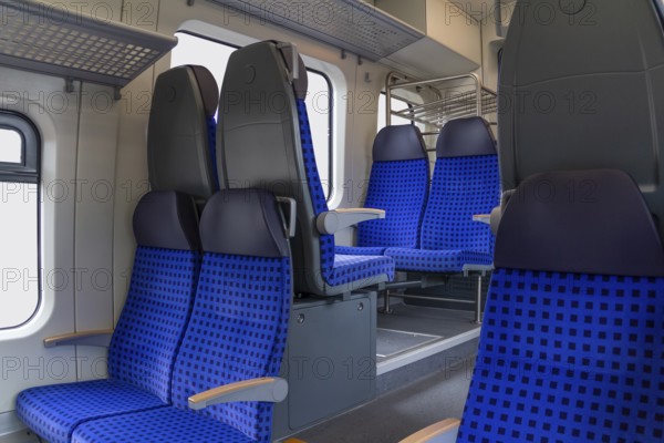 Scenery inside a railway car with blue seats