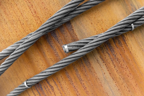 Closeup shot of wire ropes on rusty ground
