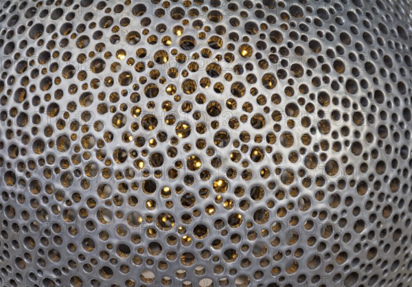Full frame bent metallic perforated background