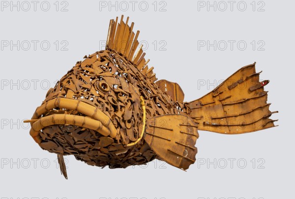 Rusty fish sculpture isolated in light back