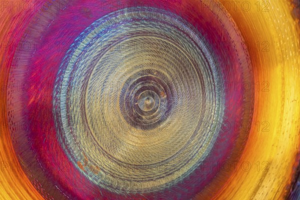 Full frame abstract detail shot of a colorful metallic gong