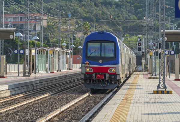 Railway station with train in Imperia, a city in Liguria, northern Italy