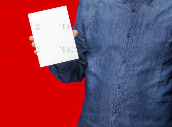 Male person holding a white blank sign in red back