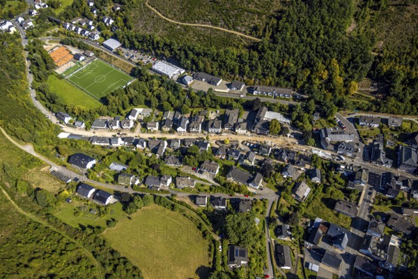 Aerial view, Hundemstraße road construction work with closure, football stadium sports field FC Kirchhundem 1946 and tennis court TC Rot-Weiß Kirchhundem, residential area, Kirchhundem, Sauerland, North Rhine-Westphalia, Germany, construction work, construction area, building site, building plots, construction measure, construction project, construction site, DE, Europe, football, football field, football stadium, property tax, real estate, aerial view, aerial photography, aerial photography, new construction, sports, sports facility, sports field, tennis, tennis facility, tennis court, tennis courts, tennis club, overview, bird's-eye view, residential complex, housing and living, quality of living, residential neighbourhood, housing estate, residential area, birds-eyes view, overview