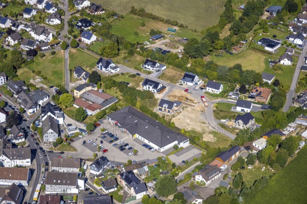 Aerial view, construction site with new construction residential area single-family houses Bockhelle, Penny supermarket, construction site Elspe, Lennestadt, Sauerland, North Rhine-Westphalia, Germany, construction work, construction area, building site, building plots, construction project, construction site, DE, single-family houses, Europe, property tax, real estate, Kirchhundem, aerial view, aerial photography, aerial photography, new building, overview, bird's-eye view, residential estate, living and living, residential area, residential buildings, residential quality, residential neighbourhood, residential estate, residential district, birds-eyes view, overview