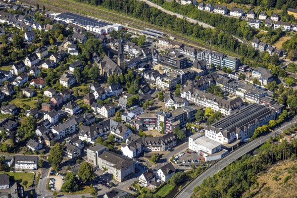 Aerial view, residential area Altenhundem with town hall Thomas-Morus-Platz, police station Bürgermeister-Beckmann-Platz, catholic parish church St. Agatha and market square, Lennestadt-Altenhundem railway station, HIT supermarket and Aldi supermarket above, Altenhundem, Lennestadt, Sauerland, North Rhine-Westphalia, Germany, place of worship, railway premises, railway station, platform, authority, community centre, DE, Deutsche Bahn AG, shopping centre, shopping markets, shopping square, shopping centre, Europe, religious community, railway tracks, tracks, house of worship, holy place, church, parish, Kirchhundem, denomination, aerial view, aerial photography, aerial photography, local supply centre, police, police station, police station, town hall, religion, religious site, shopping centre, state authority, state power, city administration, overview, bird's-eye view, overview
