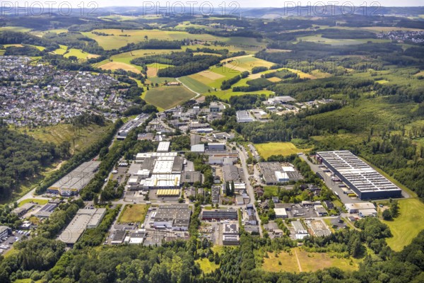 Aerial view, commercial area Wiebelsheide, behind residential area local view Herdringen, forest and meadows, distant view and blue sky with clouds, Herdringen, Arnsberg, Sauerland, North Rhine-Westphalia, Germany, commercial area, Wiebelsheide, residential area, local view, forest, meadows, distant view, blue sky, clouds, industrial area, residential buildings, nature, landscape, urban, rural, building, infrastructure, sky, daylight, village, trees, fields, real estate, region, development, perspective, bird's eye view
