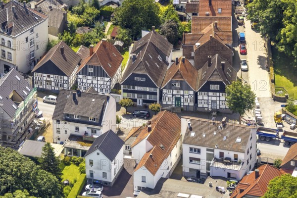 Aerial view, housing estate and half-timbered houses at the corner of Mendener Straße and Fresekenplatz, Neheim, Arnsberg, Sauerland, North Rhine-Westphalia, Germany, housing estate, half-timbered houses, Mendener Straße, Fresekenplatz, architecture, houses, streets, town, building, settlement, village, historic, traditional, roofs, residential area, urban, landscape, bird's eye view, town centre, region, typical, German, traffic, infrastructure, real estate, neighbourhood, picturesque