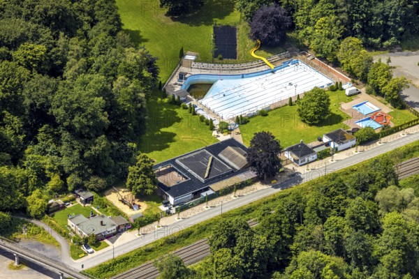 Aerial view, outdoor swimming pool Neheim, swimming pool without water, in the forest area at the river Ruhr, Neheim, Arnsberg, Sauerland, North Rhine-Westphalia, Germany, swimming pool, without water, forest area, river Ruhr, swimming pool, outdoor, empty, unused, nature, trees, landscape, green, surroundings, river bank, summer, infrastructure, recreation area, leisure, architecture, drone shot, bird's eye view, terrain, close-up, outdoor area