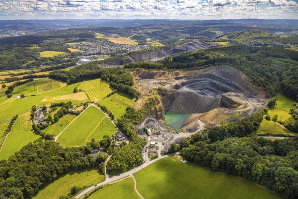 Aerial view, quarry Am Teussenberg, Ebel Steinbruchbetriebe Werk SBH, meadows and forest, distant view and blue sky with clouds, Herdringen, Arnsberg, Sauerland, North Rhine-Westphalia, Germany, quarry, Am Teussenberg, Ebel Steinbruchbetriebe, Werk SBH, meadows, forest, distant view, blue sky, clouds, nature, industry, landscape, trees, green areas, rocks, quarrying, day, aerial view, panorama, rural, environment, infrastructure, geology