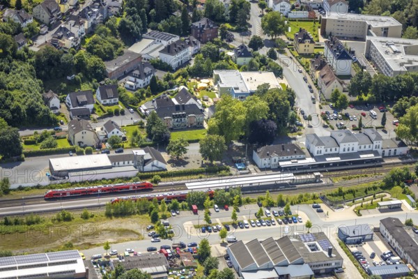 Aerial view, Arnsberg-Neheim-Hüsten railway station, Hüsten, Arnsberg, Sauerland, North Rhine-Westphalia, Germany, railway station, Arnsberg-Neheim-Hüsten, train, tracks, rails, building, architecture, city, traffic, transport, infrastructure, region, landscape, surroundings, bridge, roads, cars, trees, roofs, trains, journey, destination, station, sky, perspective, above, summer, day, clouds, urban
