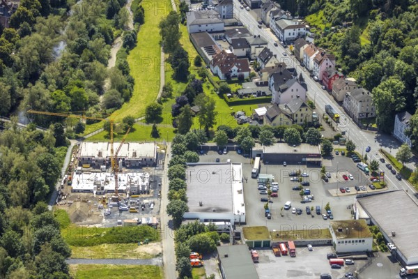 Aerial view, construction site with new building next to the fire brigade fire station on the river Ruhr, Obereimer, Arnsberg, Sauerland, North Rhine-Westphalia, Germany, construction site, new building, fire brigade, fire station, river, Ruhr, building, construction, architecture, city, river bank, landscape, infrastructure, development, urban, water, green areas, industry, residential area, construction project, modern, from the air, helicopter, bird's eye view, construction cranes, blue, green, order, planning
