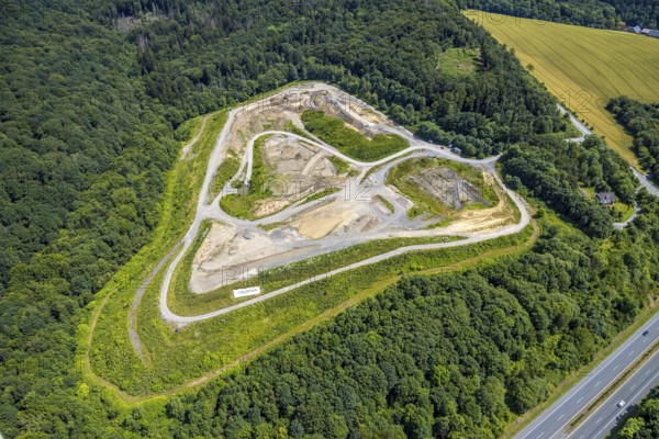 Aerial view, Feldhaus landfill in the forest area on the A46 motorway, Arnsberg, Sauerland, North Rhine-Westphalia, Germany, landfill, Feldhaus, forest area, motorway, A46, infrastructure, disposal, waste, forest, road, traffic, landscape, environment, movement, recycling, nature, industry, settlement, geographical, trees, vehicles, aerial view, view from above, daylight, order, disposal facility, structure, transport routes