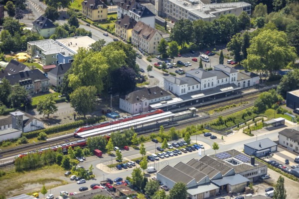 Aerial view, Arnsberg-Neheim-Hüsten station, S-Bahn in station, Hüsten, Arnsberg, Sauerland, North Rhine-Westphalia, Germany, railway station, Arnsberg-Neheim-Hüsten, S-Bahn, railway, train, rails, tracks, infrastructure, traffic, city, urban, building, architecture, transport, travel, commuter, region, aerial view, wide view, landscape, junction, railway station, platform, public transport, exterior view, overview