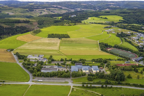 Aerial view, Ludwig-zu-Sayn-Wittgenstein-Schule Hauptschule and Städt. secondary school, meadows and fields, wooded area with forest damage and hilly landscape, Bad Berleburg, Wittgensteiner Land, North Rhine-Westphalia, Germany, view, education, trees, fields, geography, green area, secondary school, hilly landscape, infrastructure, landscape, agriculture, Ludwig-zu-Sayn-Wittgenstein-Schule, nature, panorama, secondary school, tranquillity, school, daylight, territory, environment, wooded area, forest damage, meadows, rural, vegetation