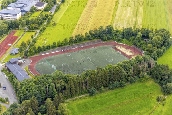 Aerial view, football stadium athletics stadium Auf dem Stöppel, sports field Bad Berleburg, youth players on the field, Bad Berleburg, Wittgensteiner Land, North Rhine-Westphalia, Germany, architecture, athletes, outdoor shot, building, field, leisure, football, football stadium, green area, sky, youth, youth players, landscape, athletics, athletics stadium, team sport, summer, playing field, sport, sports field, sports event, stadium, day, training, stands, competition, competition, rural
