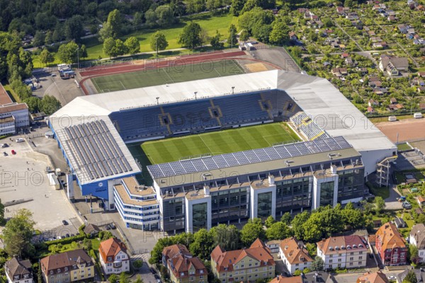 Aerial view, football stadium SchücoArena of DSC Arminia Bielefeld, also Almstadion or Bielefelder Alm, solar roof, centre, Bielefeld, East Westphalia, North Rhine-Westphalia, Germany, football stadium, SchücoArena, DSC Arminia Bielefeld, Almstadion, Bielefelder Alm, sports facility, architecture, stadium, solar system, outdoor, aerial view, daylight, urban, infrastructure, football, sport, green, field, seats, capacity, leisure, venue, technology, renewable energy, arena, venue, city, landscape, building