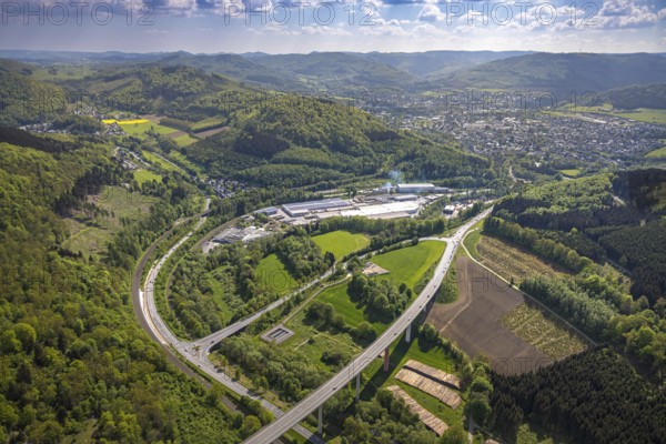 Aerial view, Ruhr valley bridge Bermecke over the river Ruhr, exit of the federal road B480n onto the main road B7, tree plantations and timber yard, industrial area with Mayr Meinhof Holz, forest area, left district Antfeld, right view to Olsberg, distant view with mountain range, Nuttlar, Bestwig, Sauerland, North Rhine-Westphalia, Germany, Ruhr valley bridge Bermecke, Ruhr river, exit, federal road B480n, main road B7, tree plantations, timber yard, industrial area, Mayr Meinhof Holz, Antfeld district, view to Olsberg, distant view, mountain range, bridge, infrastructure, traffic, nature, landscape, industry, wood processing, road course, rural, panoramic view, region, connecting road, natural resources, horizon