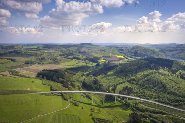 Aerial view, valley bridge Schormecke of the federal road B480 near Nuttlar, hilly landscape with meadows and fields, distant view, Nuttlar, Bestwig, Sauerland, North Rhine-Westphalia, Germany, valley bridge Schormecke, federal road B480, hilly landscape, meadows, fields, bridge, traffic, infrastructure, rural, nature, landscape, spring, summer, panorama, view, road traffic, structure, architecture, environment, region, village, infrastructure project, road traffic, traffic system, elevation, vegetation