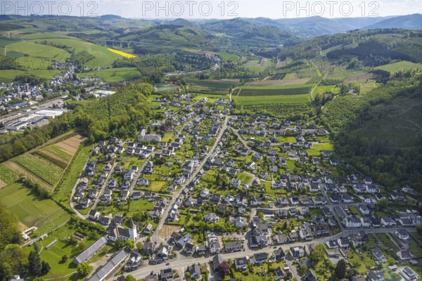 Aerial view, residential area local view district Ostwig, hilly landscape, Ostwig, Bestwig, Sauerland, North Rhine-Westphalia, Germany, residential area, local view, district, village, landscape, houses, architecture, nature, green, trees, fields, settlement, infrastructure, region, rural, Europe, German place, sky, clouds, geography, province, municipality, view, panorama, topography, spring time, peaceful, idyllic, rural area, bird's eye view