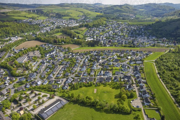 Aerial view, residential area local view Bestwig, Ostwig and Nuttlar with motorway A46 viaduct Nuttlar, in front car parks and vocational college Bergkloster with solar roof, Ostwig, Bestwig, Sauerland, North Rhine-Westphalia, Germany, residential area, local view, Nuttlar, motorway A46, viaduct Nuttlar, car parks, Berufskolleg, Bergkloster, solar roof, village, infrastructure, buildings, houses, streets, landscape, region, rural, settlement, architecture, traffic, renewable energy, solar plants, bridge, river, hill, green areas, nature, view, perspective, panorama