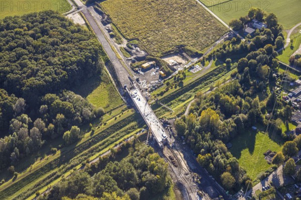 Aerial view, bypass construction site with bridge construction of the state road L821n over the Kuhbach, Oberaden, Bergkamen, Ruhr area, North Rhine-Westphalia, Germany, bypass, construction site, bridge construction, state road L821n, Kuhbach, infrastructure, construction, project, traffic, road construction, bridge, river, overpass, landscape, urban planning, development, construction work, machinery, technology, engineering, modern, transport, industry, environment, urbanisation, region, architecture, work, management, engineers, excavators, cranes, vehicles, sky, fields, railings, infrastructure project, construction site activity, daylight, perspective