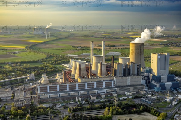Aerial view, lignite-fired power plant Niederaußem, power plant site of RWE Power AG, cooling towers and smoke clouds, distant view, behind the RWE Power AG power plant Neurath, Bergheim, Rhineland, North Rhine-Westphalia, Germany, lignite-fired power plant, Niederaußem, RWE Power AG, cooling towers, smoke clouds, Neurath power plant, energy, industry, environment, smoke, emissions, pollution, technology, architecture, infrastructure, power generation, landscape, sky, clouds, perspective, air pollution, energy production, sustainability, coal power, ecological footprint, energy production, energy industry
