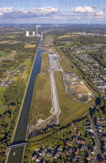 Aerial view, Wasserstadt Aden on the Datteln-Hamm Canal, construction area for planned urban quarter on the site of the former Haus Aden colliery, behind the Bergkamen power station, distant view and blue sky with clouds, Oberaden, Bergkamen, Ruhr area, North Rhine-Westphalia, Germany, Wasserstadt, Aden, Datteln-Hamm Canal, construction area, urban district, former colliery, Haus Aden, power station, distant view, blue sky, clouds, development, planning, industry, architecture, river, infrastructure, urban development, landscape, canal, energy, industrial area, urban, view, building, geography, environment, sky, cloud formations
