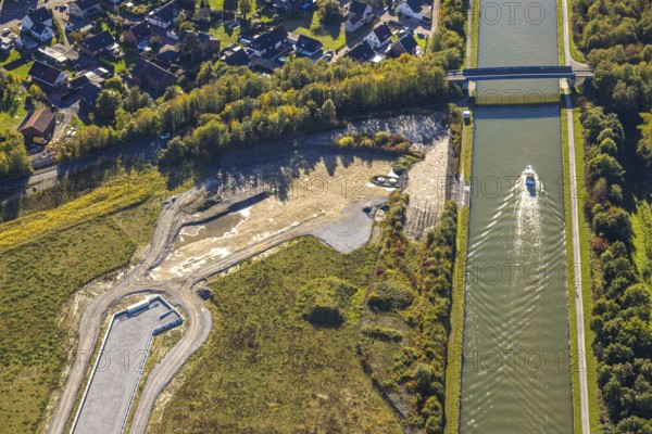Aerial view, Aden water town on the Datteln-Hamm Canal with ship, construction area for planned urban quarter on the site of the former Haus Aden colliery, Oberaden, Bergkamen, Ruhr area, North Rhine-Westphalia, Germany, Aden, architecture, construction work, construction area, Datteln-Hamm Canal, development, river, building, site, Haus Aden, horizon, industrial history, infrastructure, construction, landscape, aerial view, modernisation, perspective, ship, shipping, urban development, urban planning, urban quarter, technology, transport, water town, waterway, economy, residential area, former colliery, urban