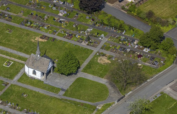 Aerial view, Nuttlar cemetery burial ground and cemetery chapel, Zum Kreuzberg, Nuttlar, Bestwig, Sauerland, North Rhine-Westphalia, Germany, cemetery, burial ground, cemetery chapel, overhead, chapel, gravestones, gravesites, memorial, landscape, village, church, religion, rest, peace, remembrance, respect, tradition, architecture, settlement, sky, building, trees, dignity, mourning, remembrance, structured layout, environment, nature, place, aerial view, dawn, historical