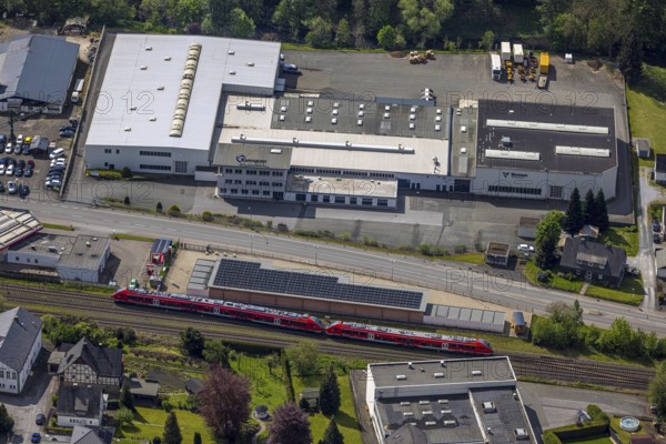 Aerial view, Briloner Straße industrial estate with Ramspott GmbH and Vermeer Deutschland, XXL Garagen and AVIA Mikus Nuttlar petrol station on the railway line, S-Bahn, Nuttlar, Bestwig, Sauerland, North Rhine-Westphalia, Germany, industrial estate, Briloner Straße, Ramspott GmbH, Vermeer Deutschland, XXL Garagen, AVIA Mikus Nuttlar, petrol station, railway line, industrial area, commercial buildings, vehicles, infrastructure, traffic routes, buildings, company, companies, aerial view, landscape, urban development, transport, trade, economy, architecture, roads, public transport, spatial planning, commuter, railway tracks, commercial buildings, urban