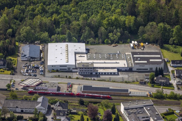 Aerial view, Briloner Straße industrial estate with Ramspott GmbH and Vermeer Deutschland, XXL Garagen and AVIA Mikus Nuttlar petrol station on the railway line, S-Bahn, Nuttlar, Bestwig, Sauerland, North Rhine-Westphalia, Germany, industrial estate, Briloner Straße, Ramspott GmbH, Vermeer Deutschland, XXL Garagen, AVIA Mikus Nuttlar, petrol station, railway line, industrial area, company, building, infrastructure, traffic, trade, business, architecture, city view, railway, train, transport, aerial view, regional, economy, development, urban area, exterior view, real estate, commercial enterprises, business environment