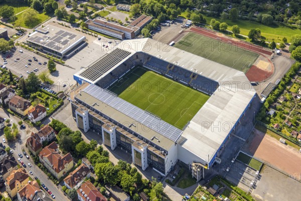 Aerial view, football stadium SchücoArena of DSC Arminia Bielefeld, also Almstadion or Bielefelder Alm, solar roof, centre, Bielefeld, East Westphalia, North Rhine-Westphalia, Germany, football stadium, SchücoArena, DSC Arminia Bielefeld, Almstadion, Bielefelder Alm, sports facility, architecture, leisure, football, sport, top view, city, urban, infrastructure, stadium, green, field, area, open-air, venue, daylight, outdoor, landscape, city view, geography, destination, sight, culture, leisure facility