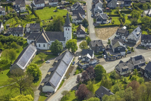 Aerial view, village centre, St. Joseph's Catholic Church, Kumm rin - Die Hofschänke with solar roof, Ostwig, Bestwig, Sauerland, North Rhine-Westphalia, Germany, Kumm rin - Die Hofschänke, solar roof, church, religion, architecture, solar energy, building, village, landscape, green spaces, streets, roofs, region, rural, infrastructure, community, photography, bird's eye view, village centre, renewable energies, autumn, daylight, historical, German village, residential buildings, trees, environmental protection