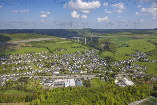 Aerial view, residential area, local view, district Nuttlar with motorway A46 viaduct Nuttlar, mountain range in the background, Ostwig, Bestwig, Sauerland, North Rhine-Westphalia, Germany, residential area, local view, district, Nuttlar, motorway, A46, viaduct, mountain range, background, infrastructure, architecture, town, village, landscape, bridge, road, traffic, nature, hill, aerial view, panorama, region, settlement, urban, rural, environment
