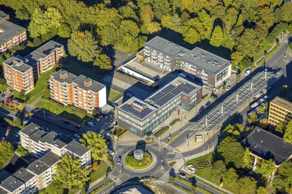 Aerial view, savings bank building at roundabout, residential area and high-rise buildings Töddinghauser Straße, ZOB bus station, Bergkamen, Ruhr area, North Rhine-Westphalia, Germany, everyday life, architecture, cars, bus station, financial building, building, commercial buildings, sky, high-rise buildings, infrastructure, roundabout, commuter, perspective, region, traveller, savings bank building, city, urban development, urban landscape, streets, day, transport, Töddinghauser Straße, urban, traffic, residential area, ZOB, European, modern, public transport